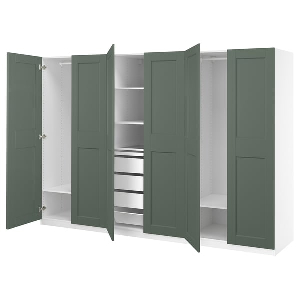 Large wardrobe with green doors, multiple shelves, and compartments. Elegant design for organised storage.