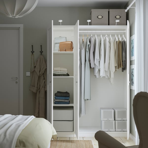 A neatly organised wardrobe with hangers, shelves, and storage boxes, showcasing the PAX systems adaptable and spacious design.
