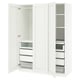 A white ikea PAX wardrobe with open doors, displaying shelves and drawers inside. Its a modern, functional design with white laminate finish.
