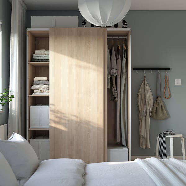 Minimalist bedroom with PAX wardrobe, efficient storage for clothes and garments.
