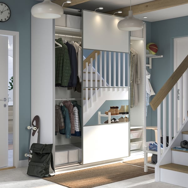 Modern closet with sliding doors, hanging clothes, shelves, and lighting.