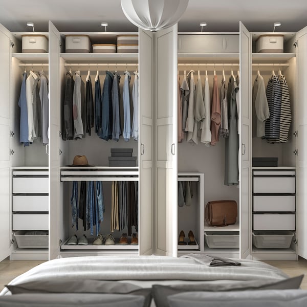 Luxury walk-in closet with organised clothing sections, drawers, shelves, and shoe racks.