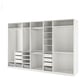 White PAX storage system with open shelves, drawers, and hanging space.
