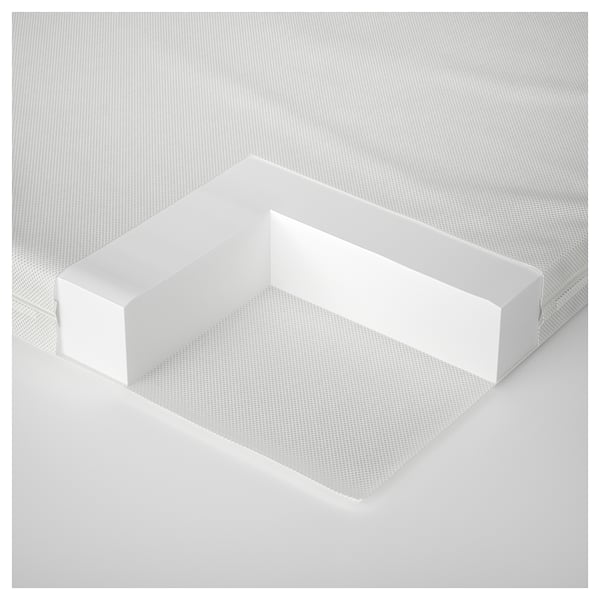 Minimalist white crib mattress with textured surface and supportive foam core.