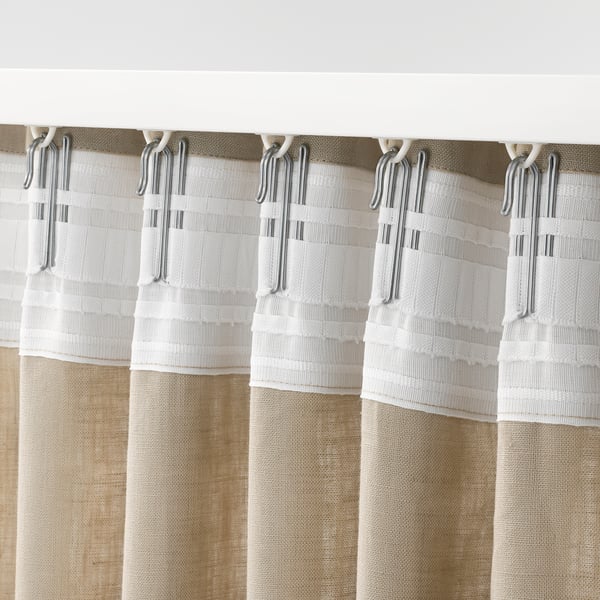 Beige curtain section with multiple clear hooks gripping white gathering tape, showcasing easy hanging functionality.