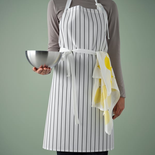 Person in striped apron holding bowl, illustrates kitchen protection and easy cleaning.