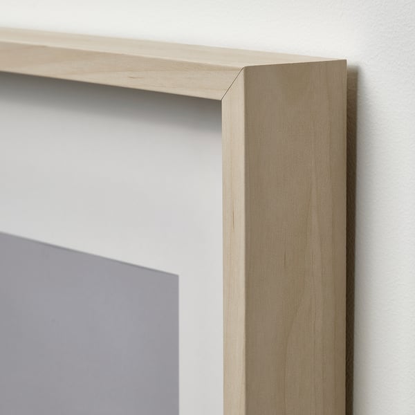 Light wood-framed picture with a grey background. High-quality, polished edges visible against a plain wall.