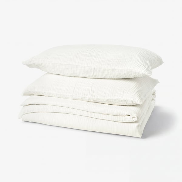 White bedding set by SCHERSMIN. Organic cotton duvet & pillowcases. Muslin design.