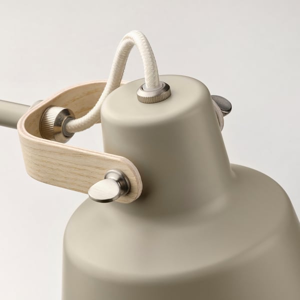 Modern lamp with light beige shade, wooden handle, and metal accents, showcasing high-quality design and materials.