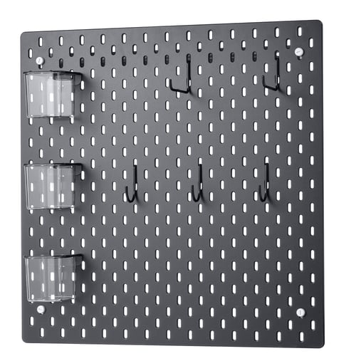 A grey SKÅDIS pegboard with hooks and containers. Its a wall-mounted organiser with a grid pattern for custom arrangement.