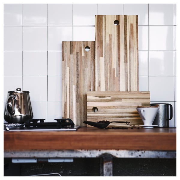 Wooden cutting boards, kitchen appliances on counter.