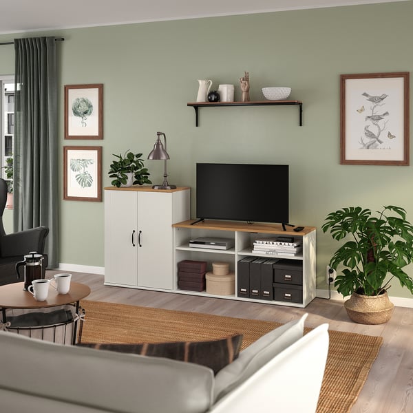Cosy living room with green walls, SKRUVBY tv cabinet, and plants.