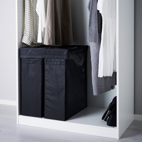 Black SKUBB laundry bags in wardrobe storing clothes and keeping floor clean.