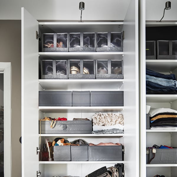 Image shows a white closet with SKUBB shoe boxes in grey on shelves, keeping items organised and visible.