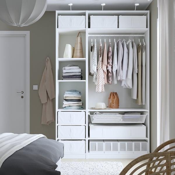 Organised closet with clothes, shelves, and storage boxes.