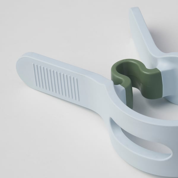 Close-up of durable white laundry peg with textured grip and green spring, showcasing quality materials and robust design.