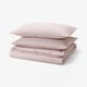 A stack of red and white striped cotton pillows and duvet.