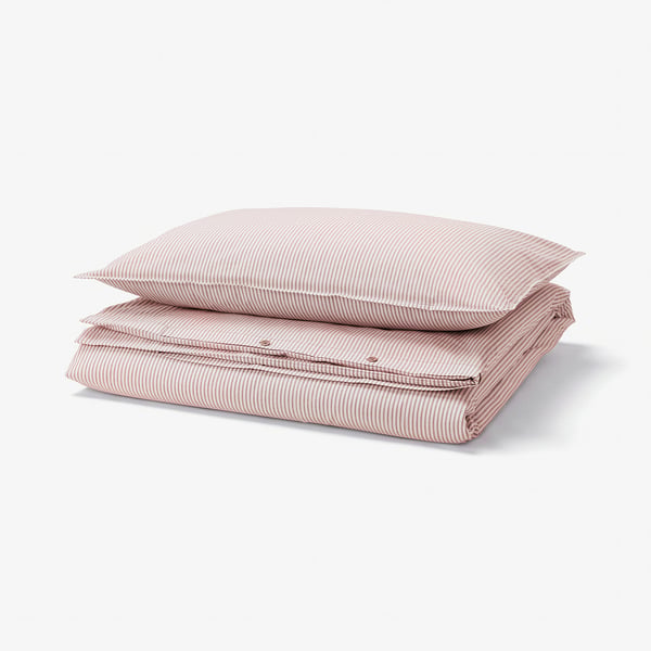 Red and white striped duvet cover and pillowcase set made from 100% cotton, neatly folded.
