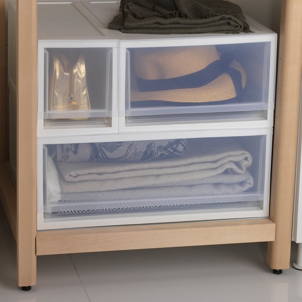 White SOPPROT storage drawers stacked with textured fabrics inside, showcasing organised and accessible storage.