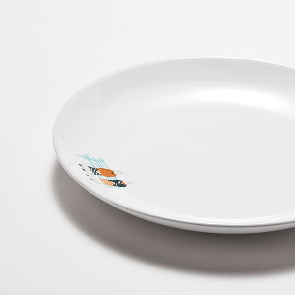 Small white plate with colourful fish design.