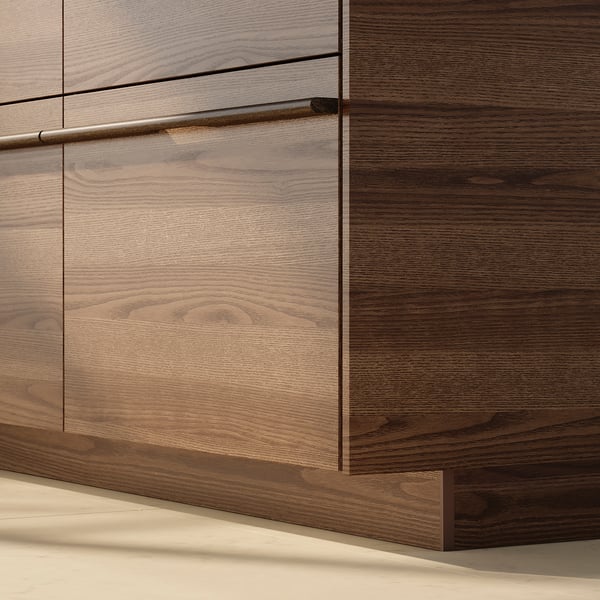 Dark brown wooden kitchen cabinets with sleek metal handles. Grain pattern visible, trimmed edges.