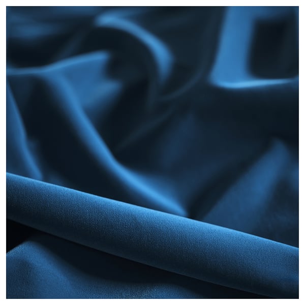 As a close-up of luxurious indigo fabric, crisply folded, showcasing smooth texture and rich depth.