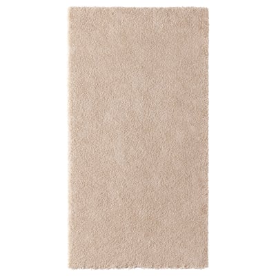 A beige-colored STOENSE rug with a soft, thick pile. Its rectangular and made from polyester and polypropylene, perfect for bedrooms.