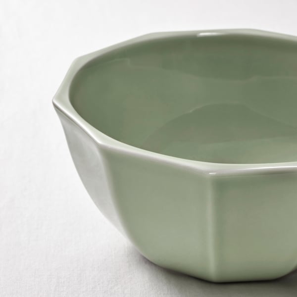 Geometric pale green bowl on white surface; smooth, glossy finish.