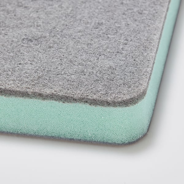 Closeup of dual-texture cleaning sponge: soft side up, rough side down.