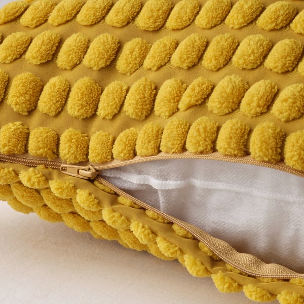 Yellow cushion with textured, tactile pattern and zip closure.