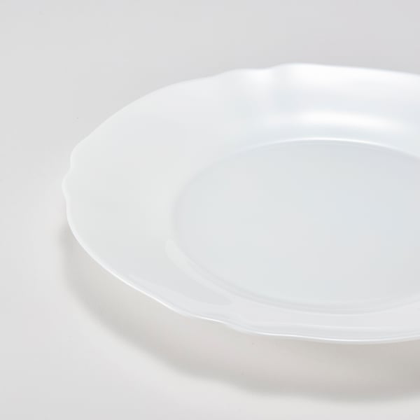 Elegant white plate with wavy edge, crafted from smooth, sturdy opal glass.