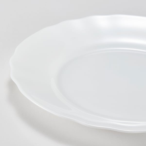 Smooth, sleek white glass plate with wavy edges, polished to perfection.