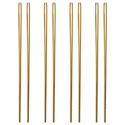 Eight pairs of TILLAGD chopsticks in brass colour, square-shaped, with non-slip surfaces, arranged neatly. Made from metallized stainless steel.