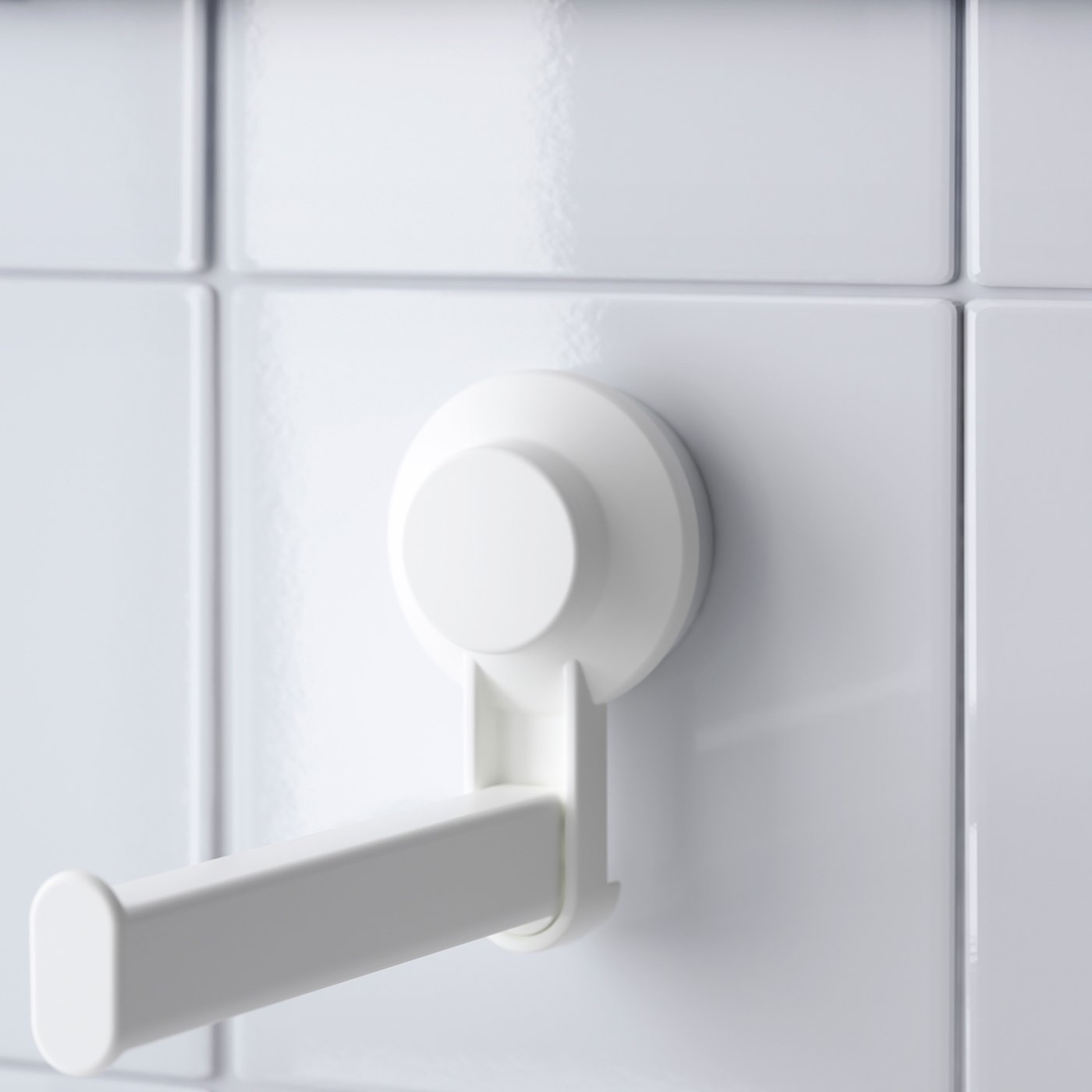 Yze white suction toilet paper holder securely mounts on tiled wall, robust plastic design.