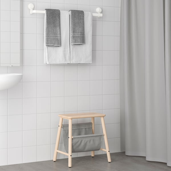 TISKEN wood & grey fabric stool, minimalist design. Folds flat, fits neatly in corner beside shower curtain.