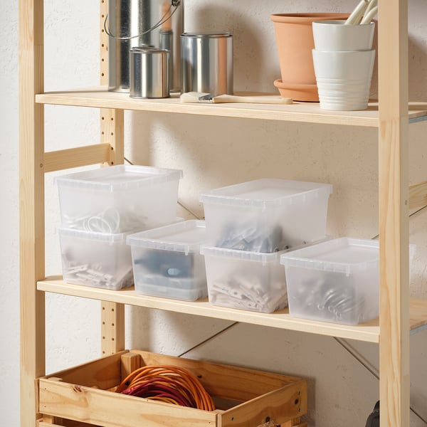 Shelf with transparent boxes, some lidded, holding various items and chords. Surrounded by plant pots and metal cans.