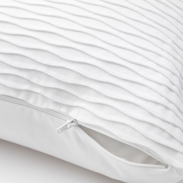 White quilted pillow with zip detail, showcasing its removable cover.