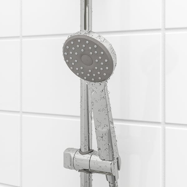 Hand shower with comfy full spray. Adjustable height. Water and energy saver. Chrome finish. Tiled wall background.