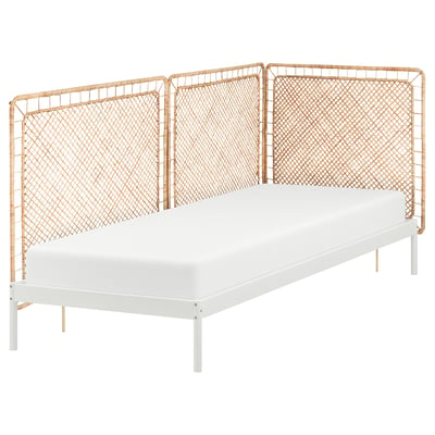 The VEVELSTAD bed a white frame with wicker headboard, combining natural rattan and metal for modern rustic appeal.