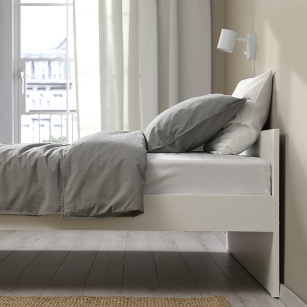 White VIHALS bed frame with city view