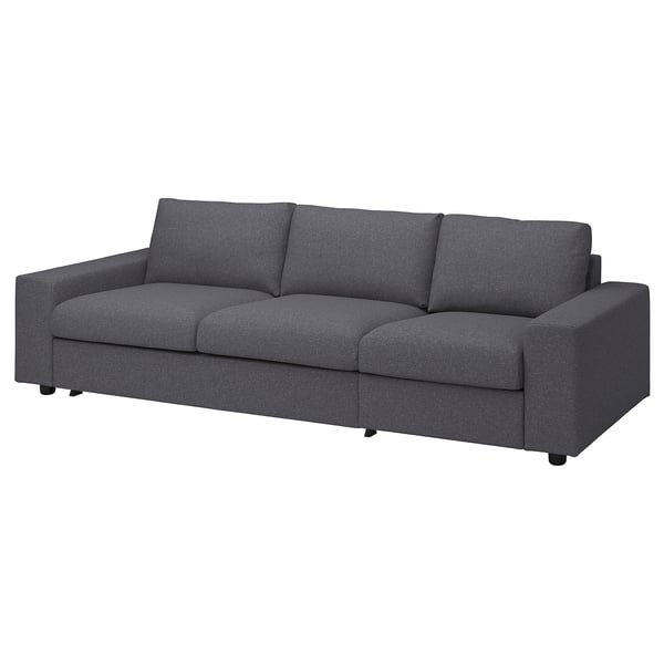 Modern dark grey fabric sofa with three back cushions and sleek, simple design.