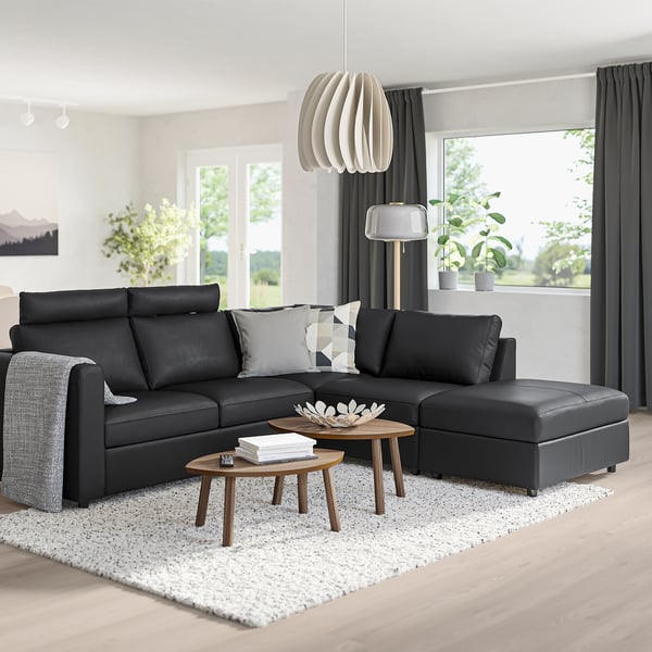 Modern living room with VIMLE sectional, ottoman, headrest, pillows, tables, light, and large window with curtains.