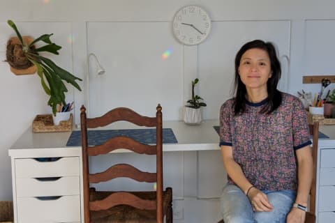 Xin Lu sitting at desk in kids playroom makeover