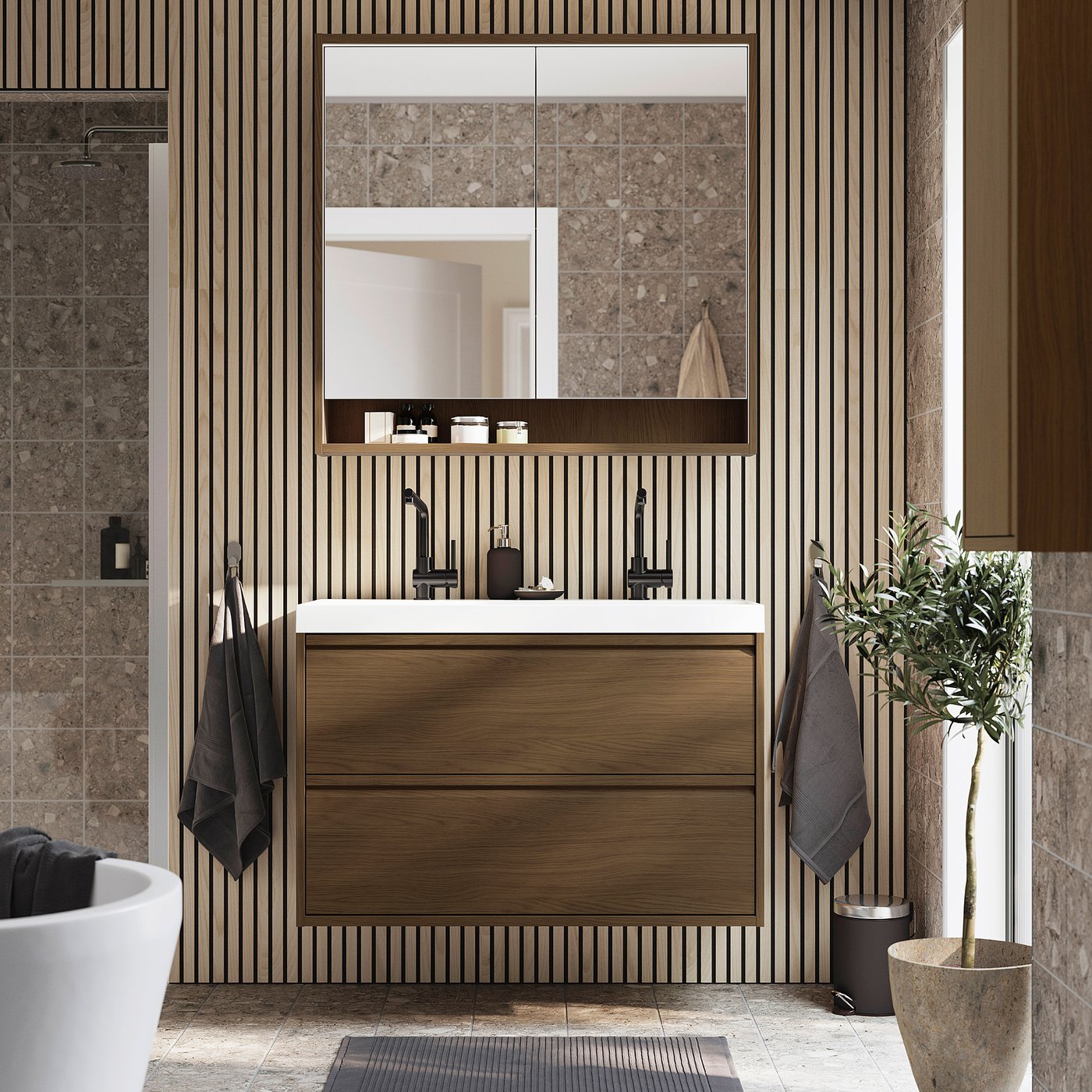 Modern bathroom with brown oak ÄNGSJÖN vanity, sink, shelves, mirror, plant & towels.