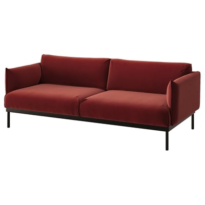 Red sofa with metal legs and velvet cover.
