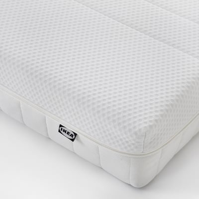 White foam mattress with textured surface and zip, corner brand label