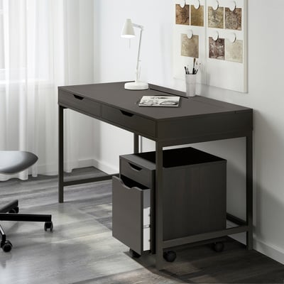 Dark grey ALEX desk with drawers, lamp, and supplies in corner.