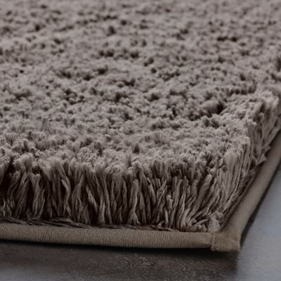Soft, plush bath mat with ultra-absorbent microfiber, secure latex backing.