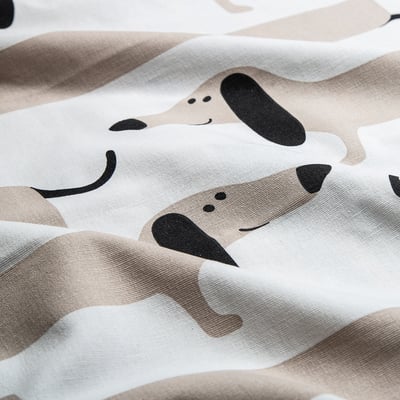 Close-up of playful dachshund print fabric, smooth cotton texture, vibrant design.
