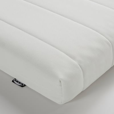 Close-up of a white, textured foam mattress showcasing its smooth, even surface and quality craftsmanship.